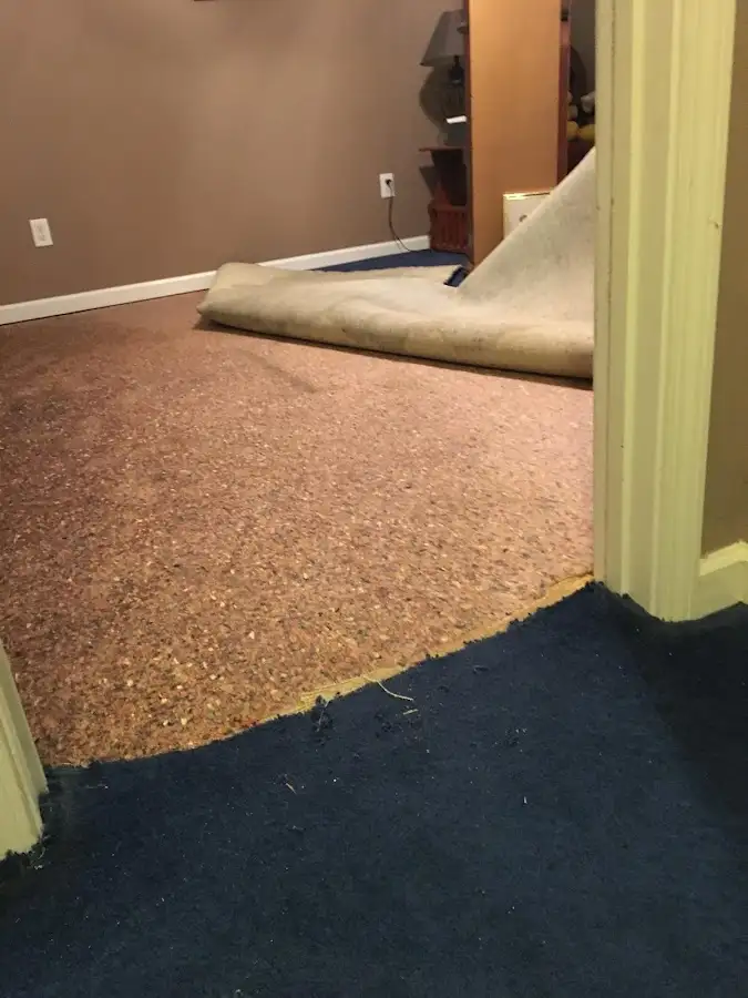 Carpet pad removal revealing water damage during Water Mitigation Services in Woodlake